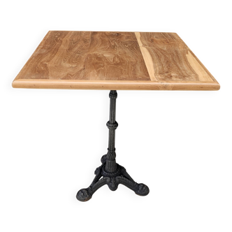 Bistro table with cast iron base and teak top