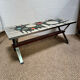 Vintage coffee table from the 60s and 70s in ceramic, chrome metal, and wood.