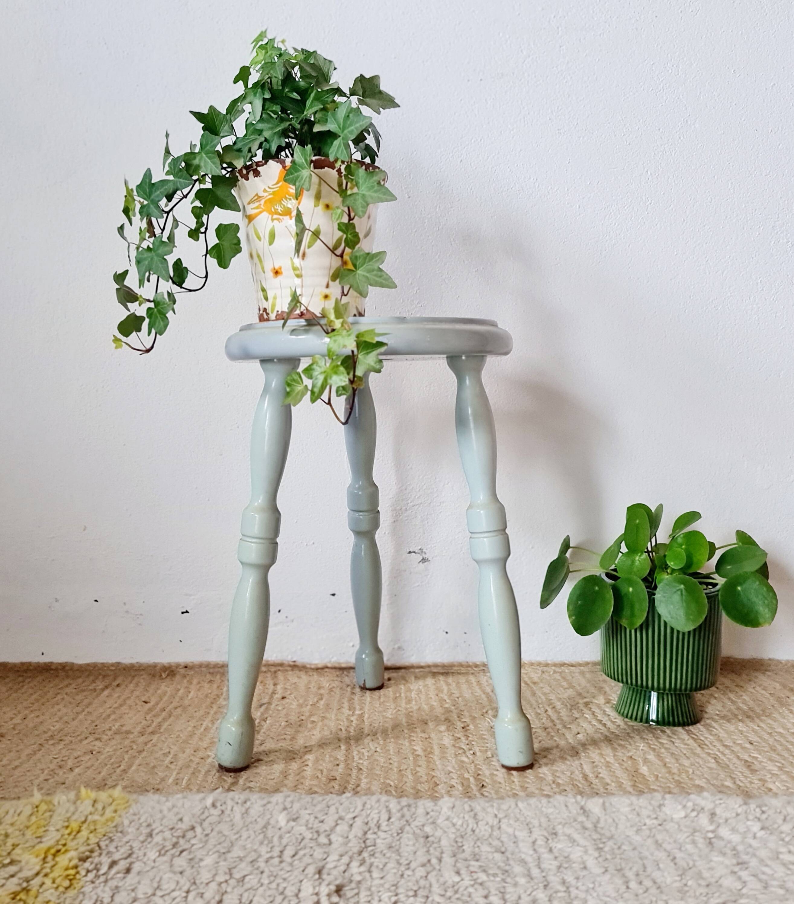 Antique tripod stool made of solid wood in blue.
