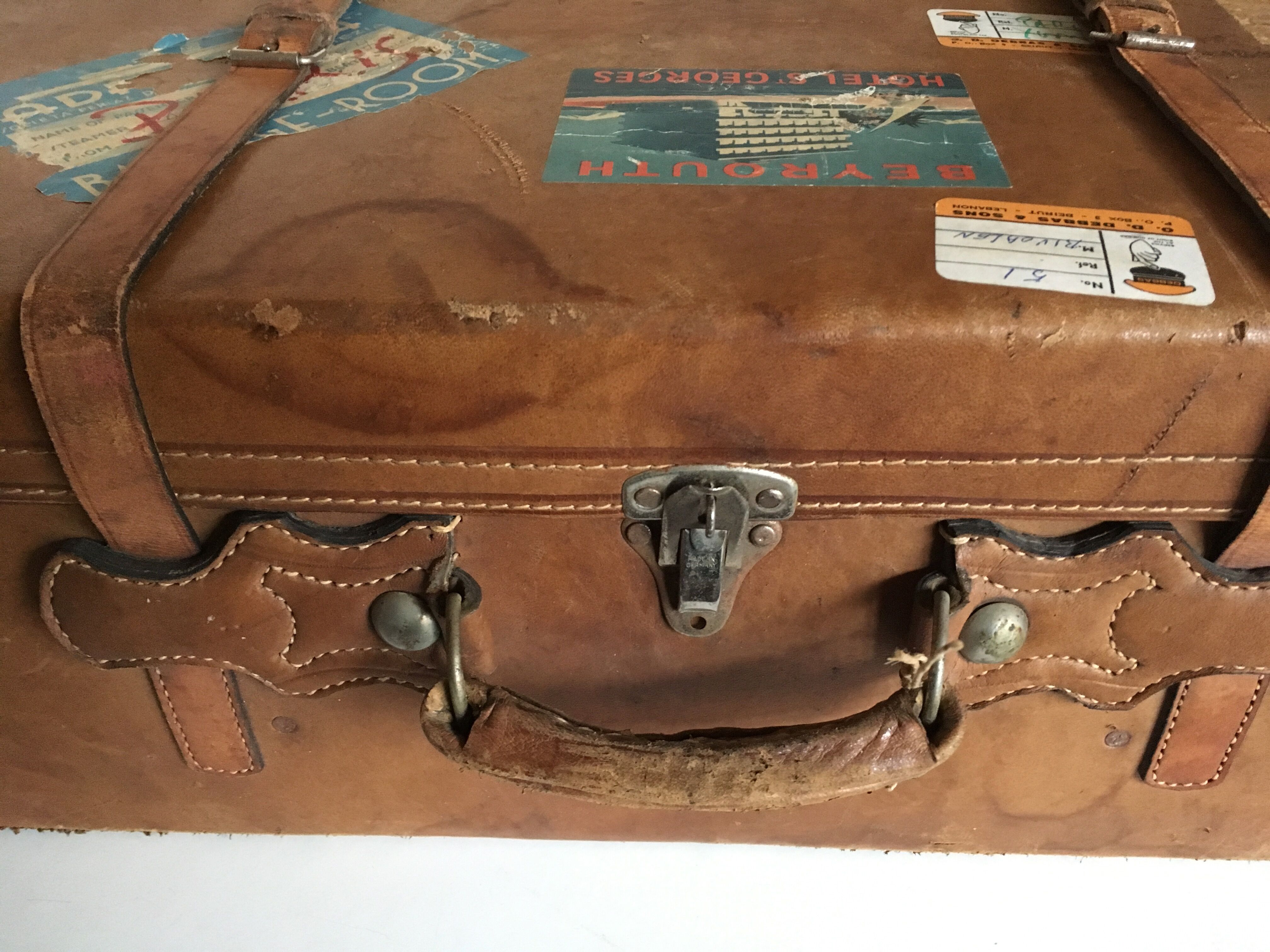 suitcase of leather with labels of palaces