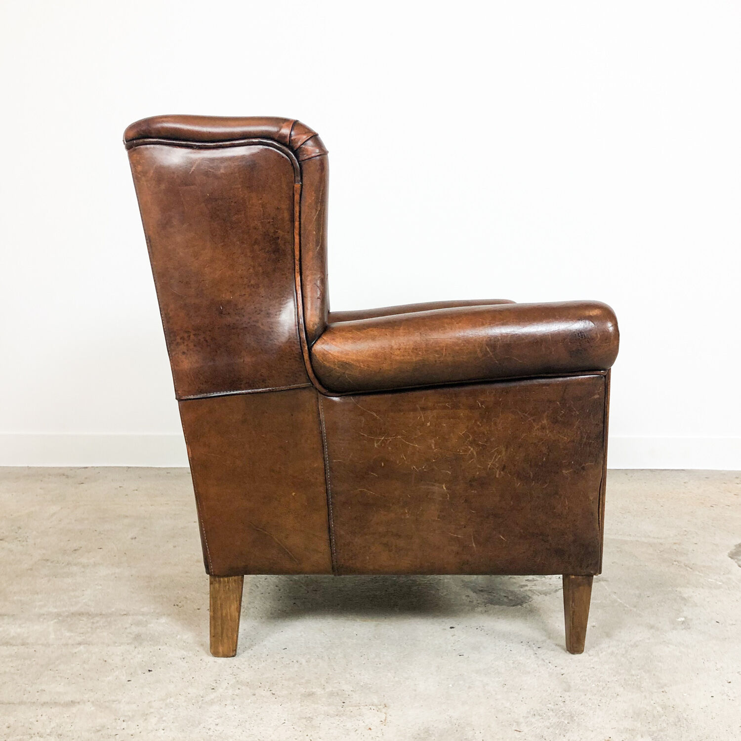 Dark brown sheep leather wingback armchair
