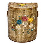 Vintage wicker mannequin with colourful floral decoration.