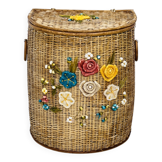 Vintage wicker mannequin with colourful floral decoration.