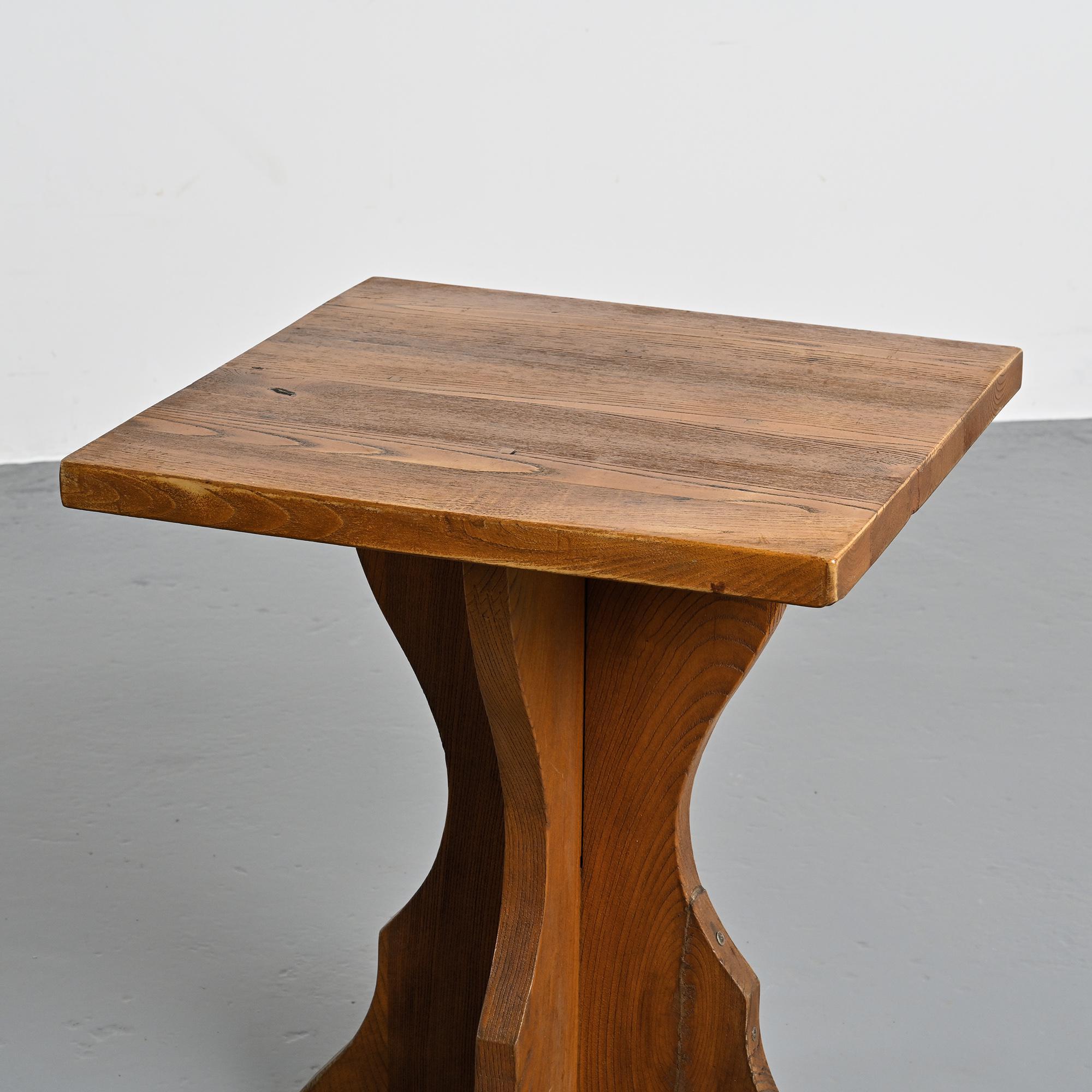 Solid pine table, sculpted cross legs, French Alps, around 1970.