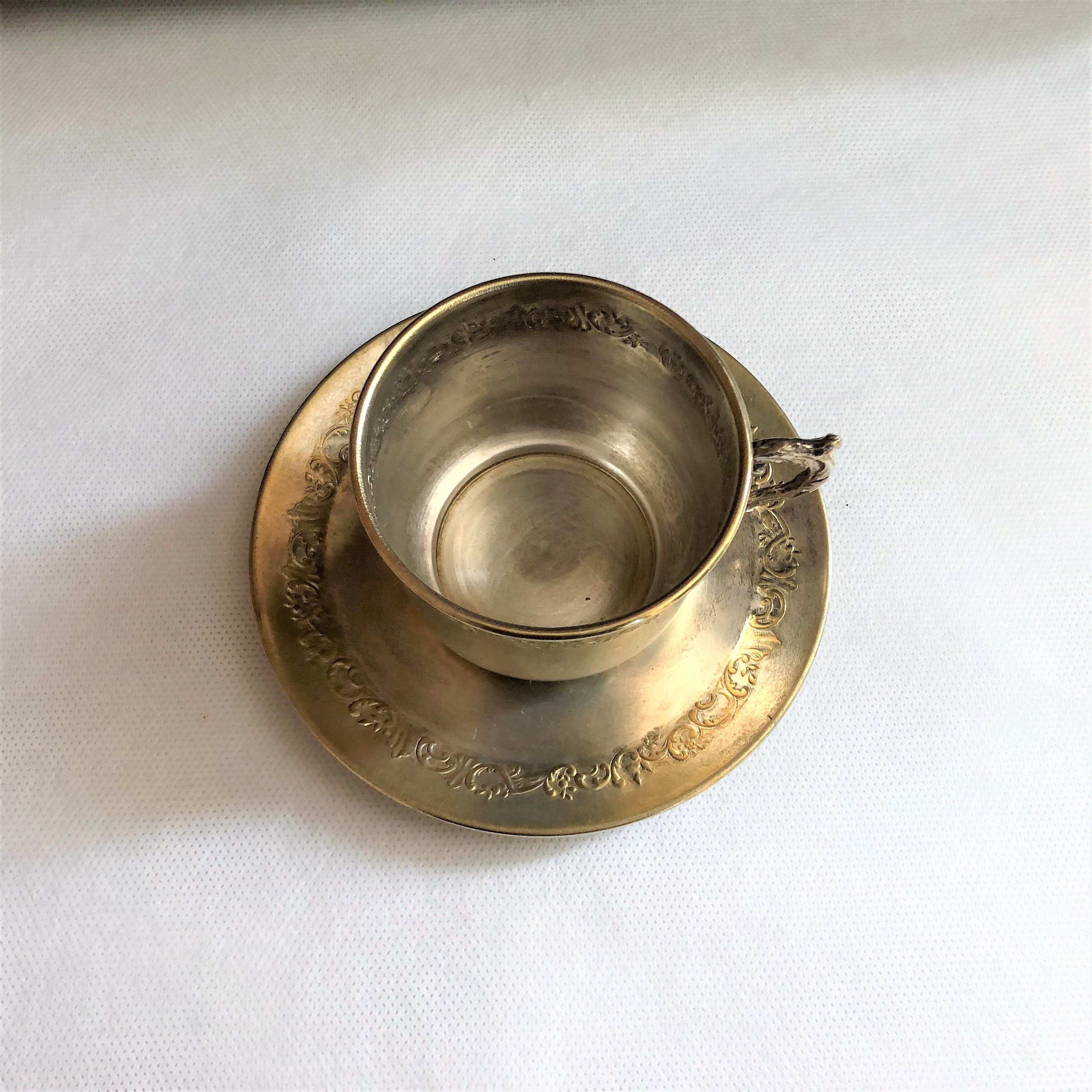 Silver metal cup and saucer