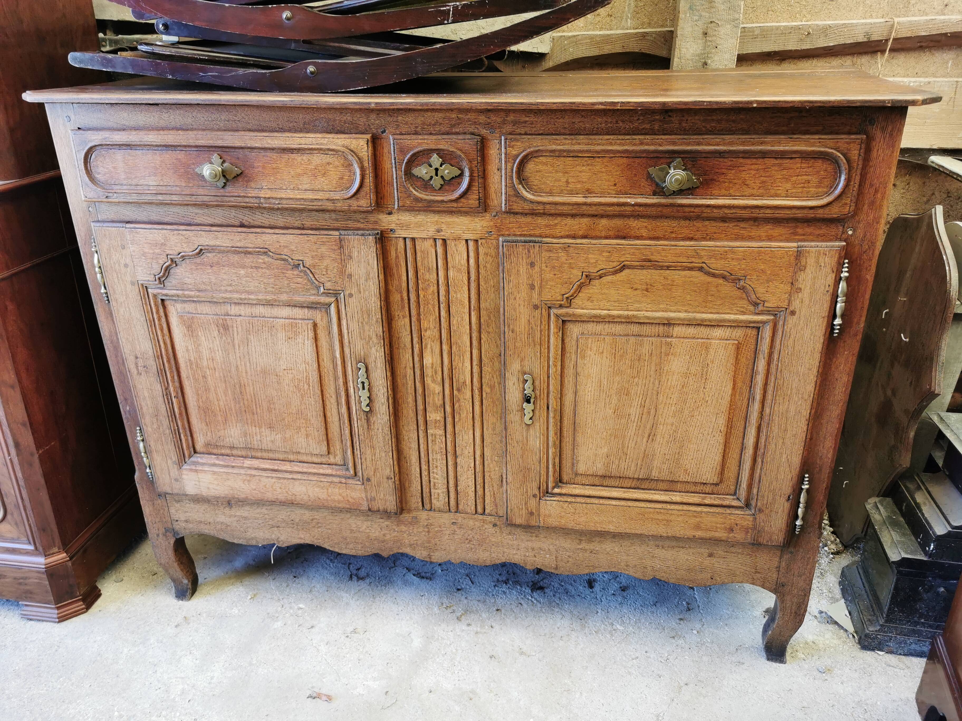 Old low buffet, 19th in rustic solid oak, carved and molded