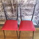 Pair of red Colette Guéden chairs