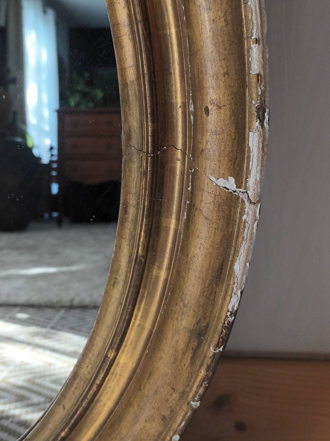 Antique oval gilded stucco mirror