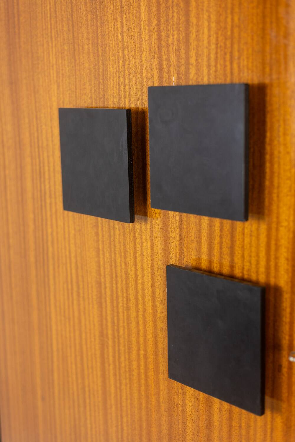 Pair of mahogany veneer and black lacquered iron cabinets. 1950s.