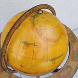 Old terrestrial globe world map on wooden stand