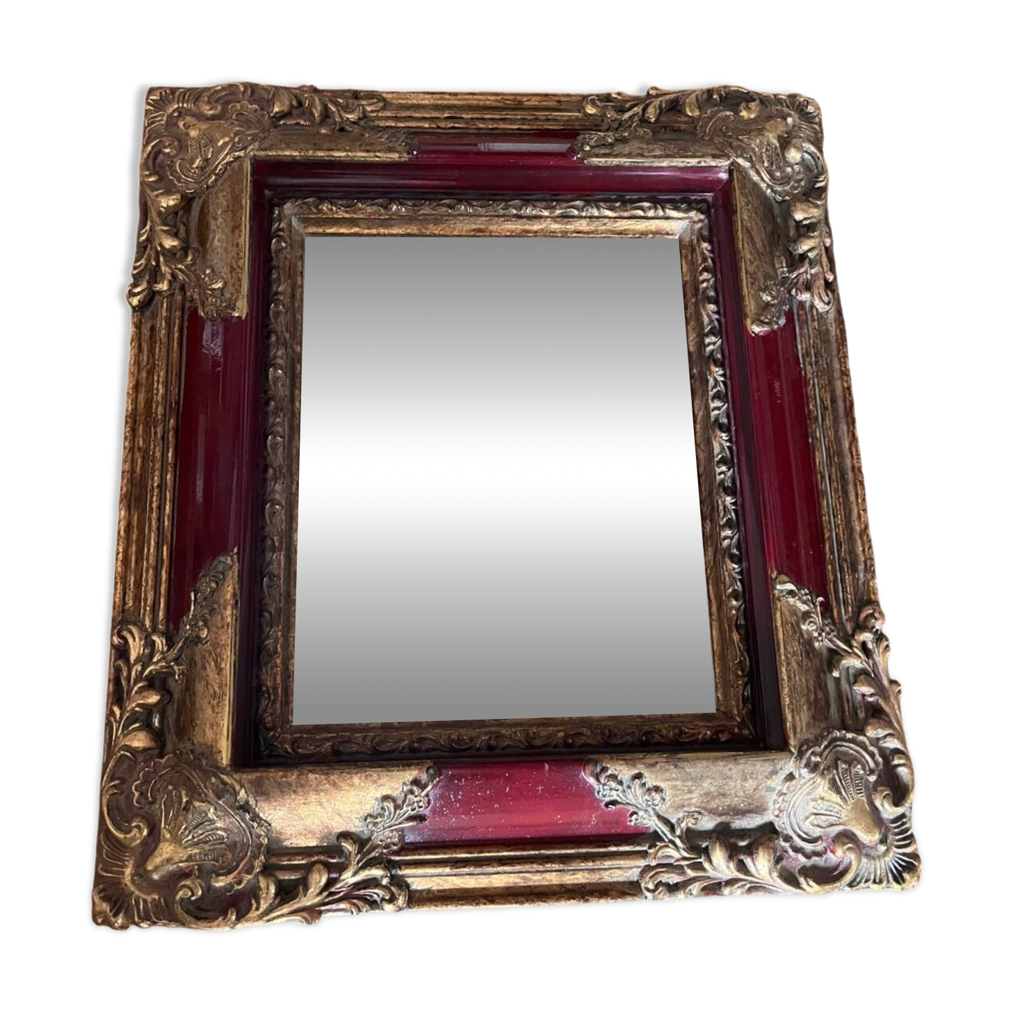 Old mirror with gold and red frame