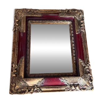 Old mirror with gold and red frame