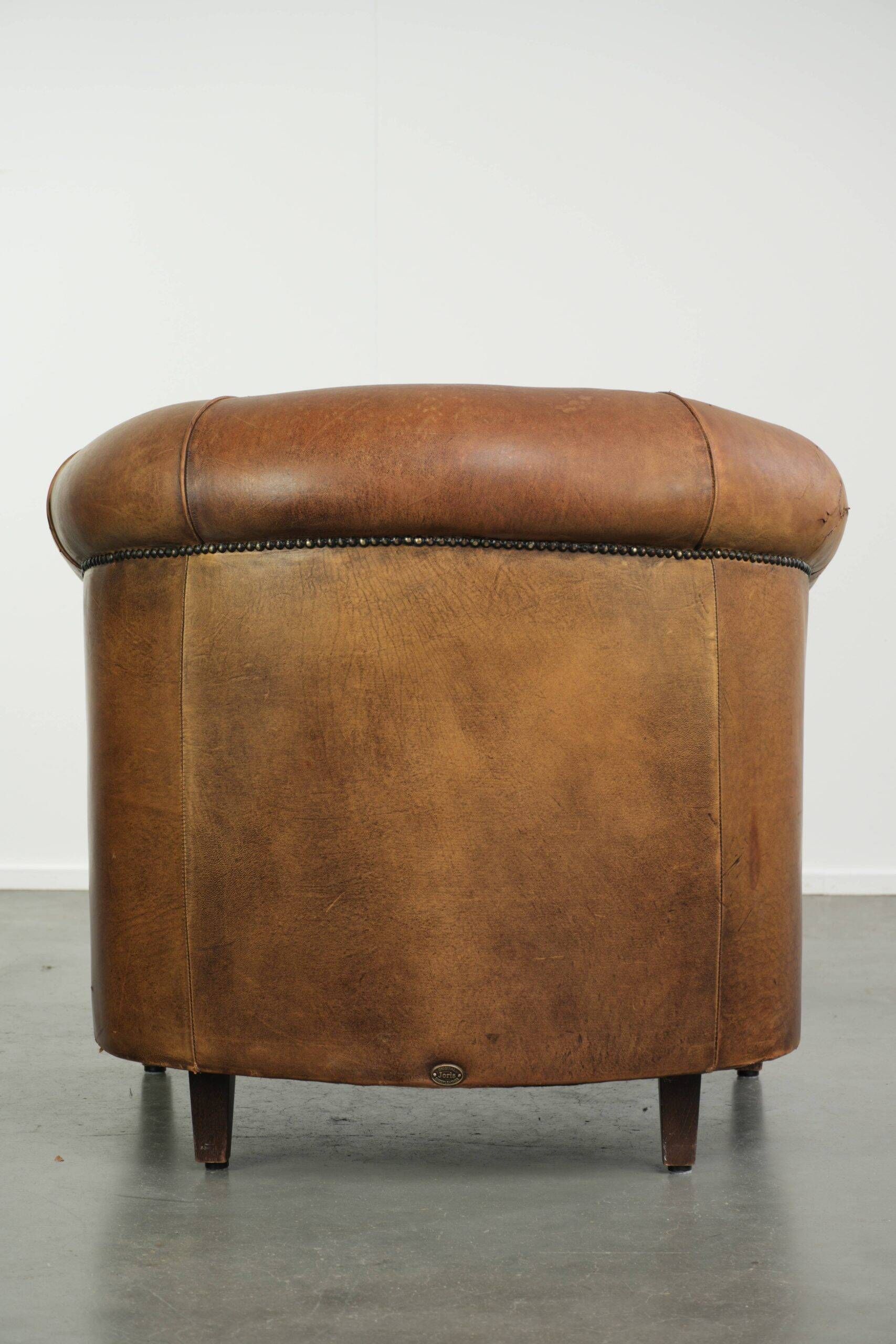 Aged sheepskin clubchair with beautiful vintage patina and comfortable seat
