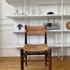 Wooden chair and brutalist straw