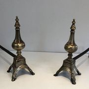 Pair of chiselled bronze and wrought iron fire dogs in the Louis XVI style.