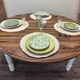 Round walnut table convertible into a console.