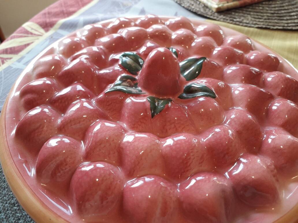 Glazed ceramic dessert plate with strawberry design.
