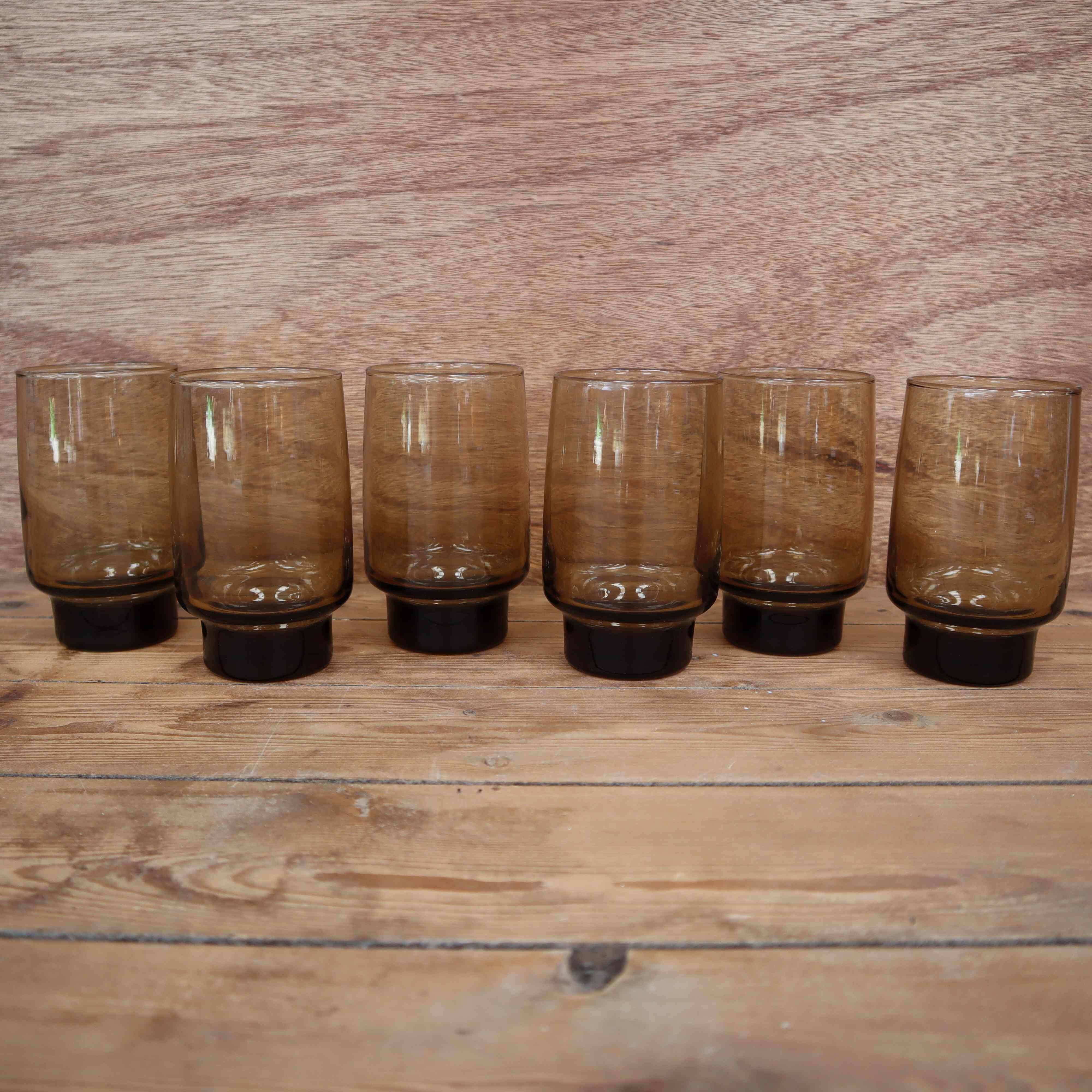 6 Smoked glasses with thick legs from the 70s