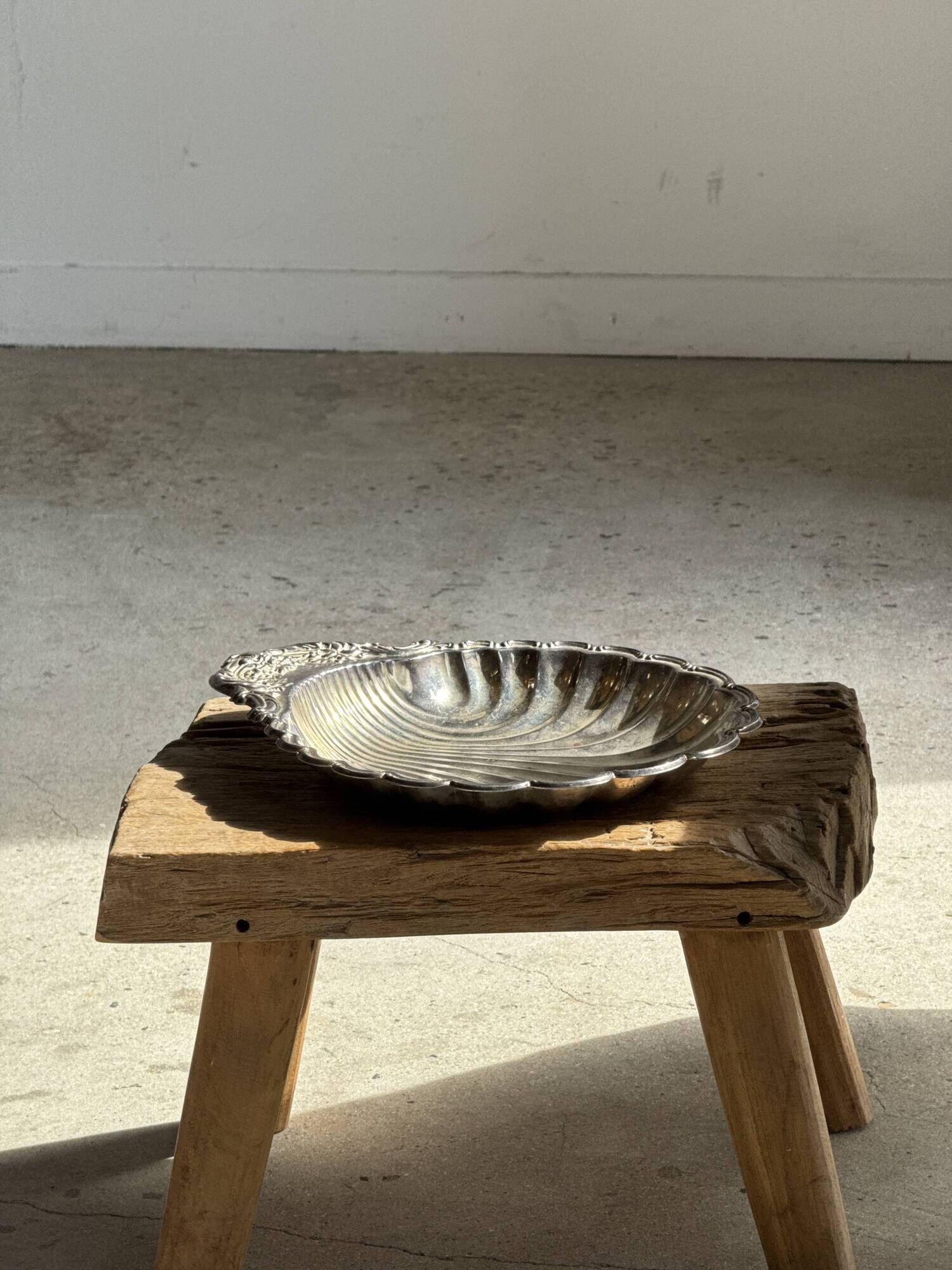 Large antique silver-plated bowl in the shape of a shell.