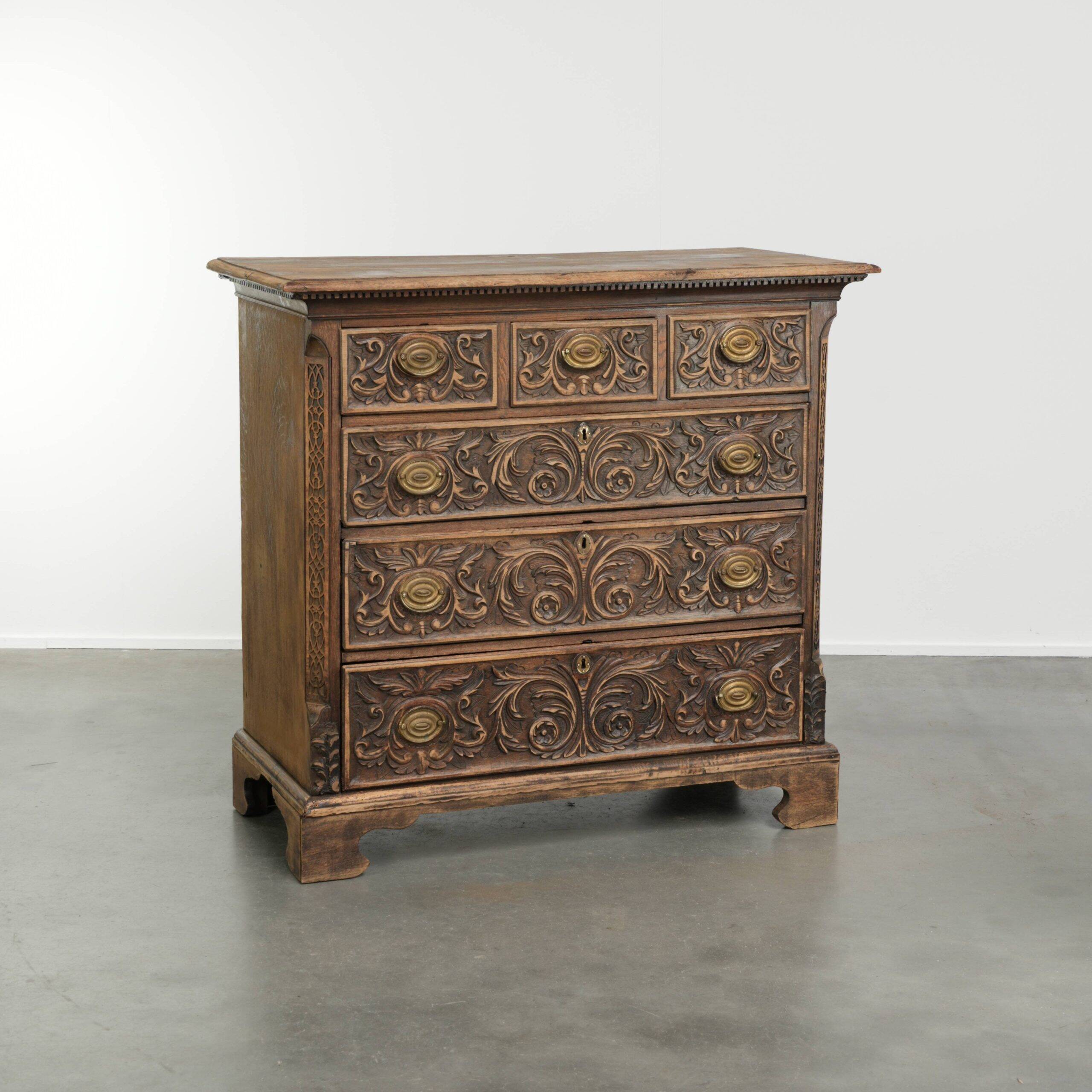 Richly carved English oak chest of drawers from the 18th century