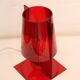 Red plastic Kartell table lamp - model Take - design by Ferruccio Laviani