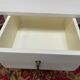 Wooden bedside table painted white