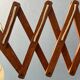 Vintage wall lamp with teak wood scissors and glass shade.