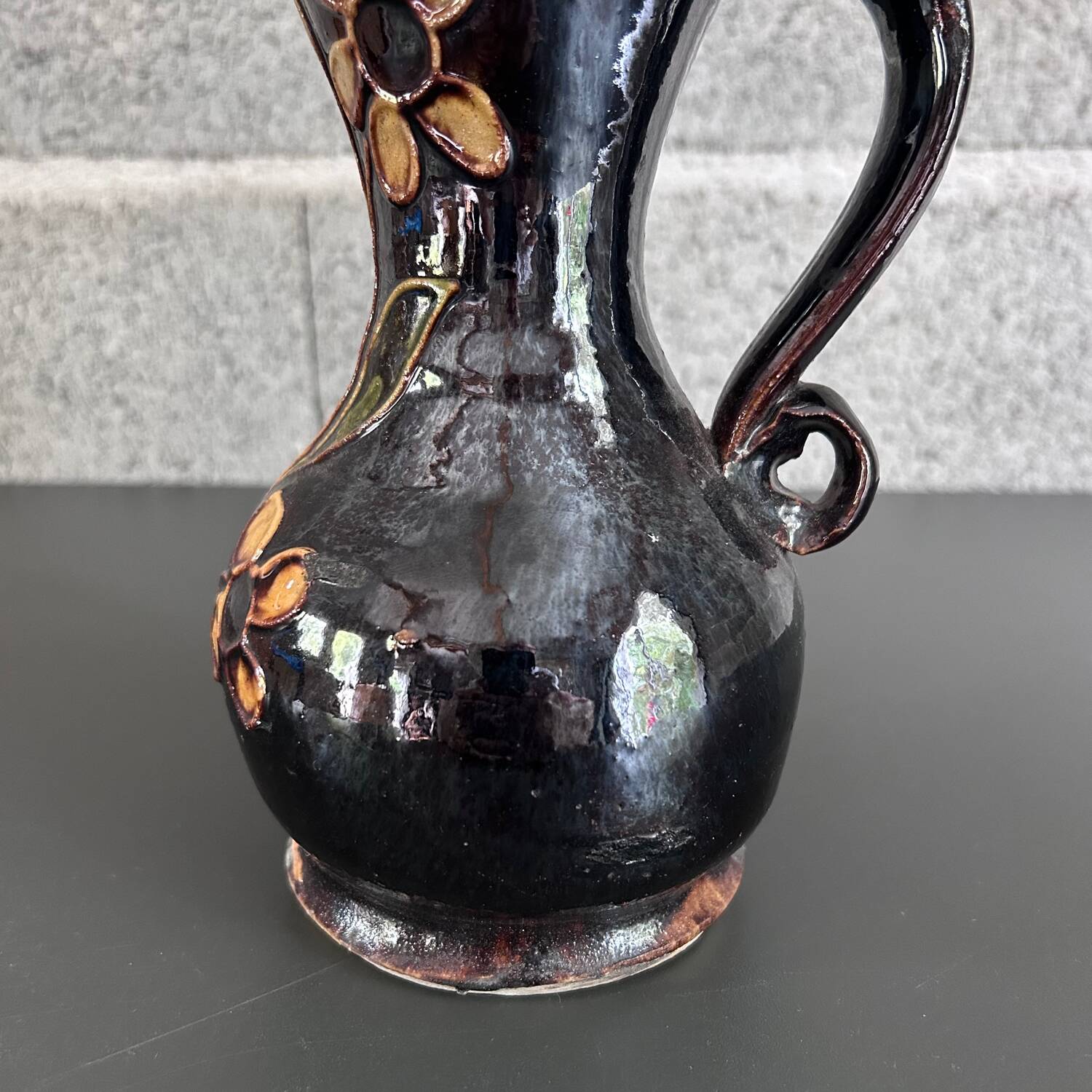 Black vase with yellow flowers