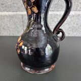 Black vase with yellow flowers