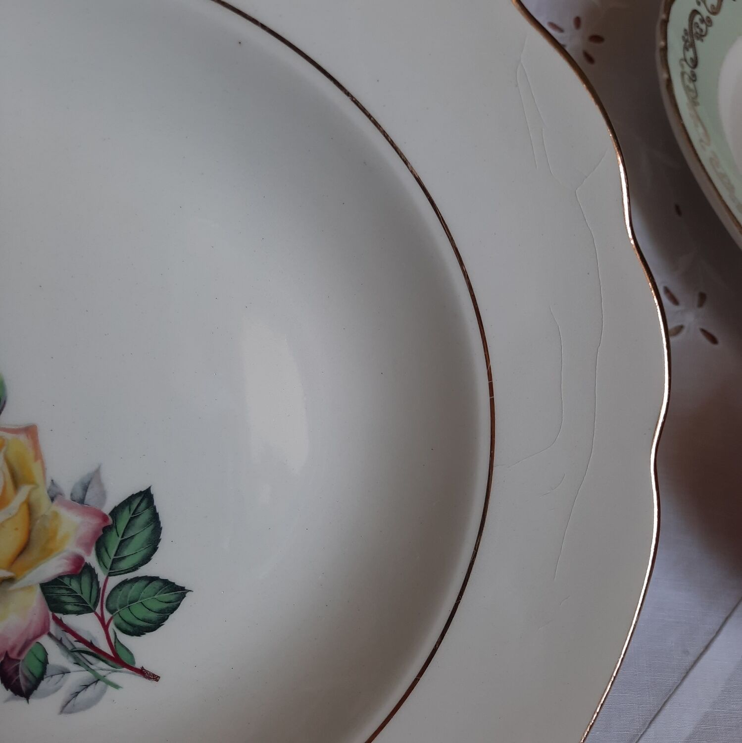 Old hollow plates mismatched in earthenware with gilded edges