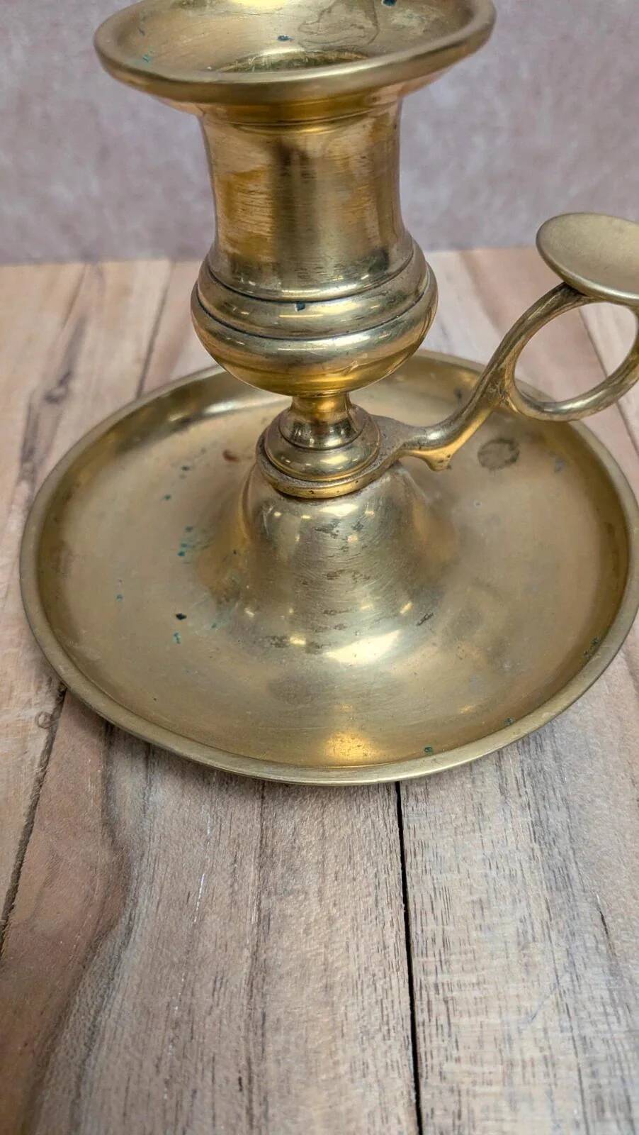 Antique brass candlestick with pusher