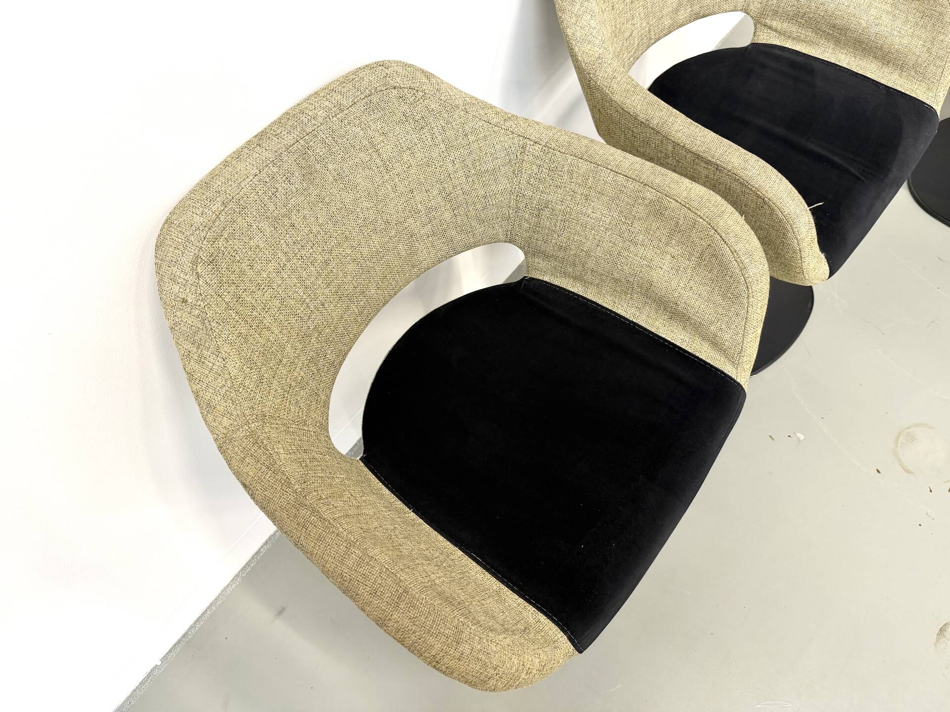 Series of six swivel chairs with an organic shell, patterned fabric and base.