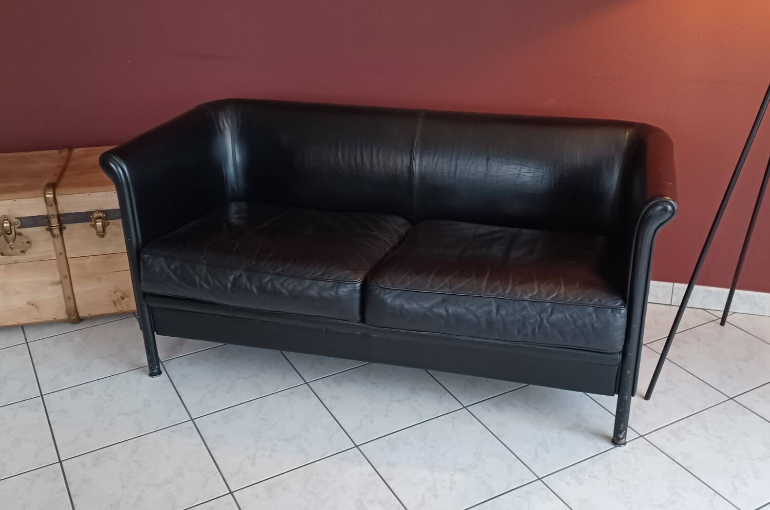 Black leather two-seater sofa