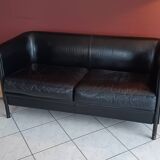 Black leather two-seater sofa