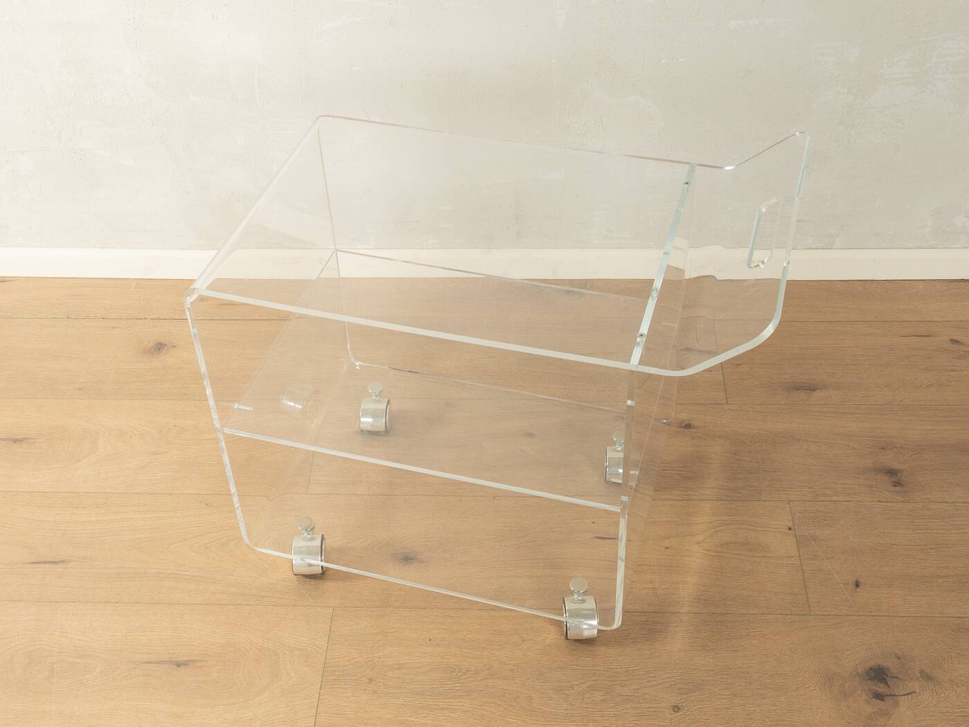 Wonderful side table from the 1960s, high-quality frame and shelf made of transparent acrylic with chrome-plated castors