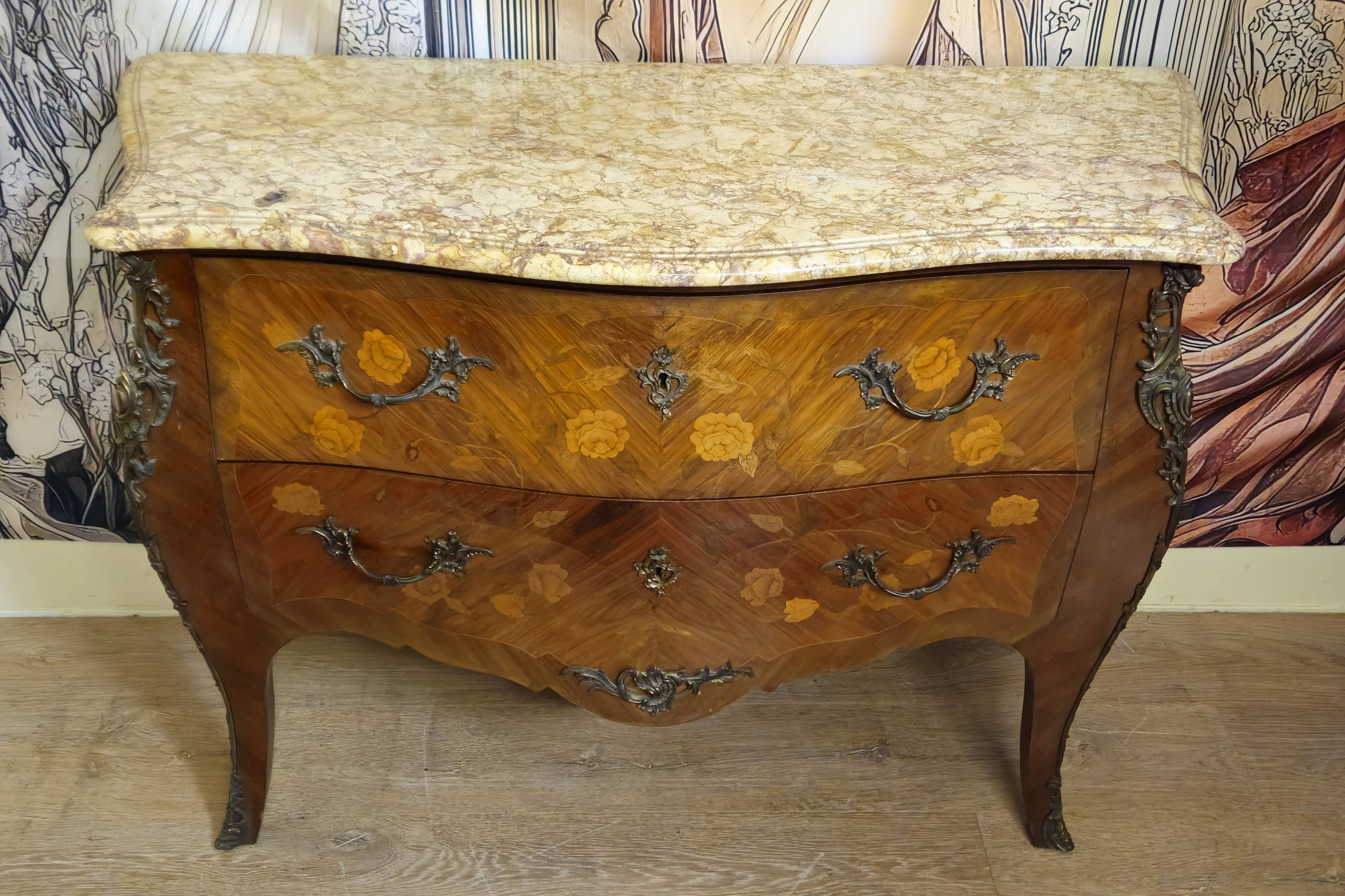 Curved Louis XV style commode with floral marquetry and marble top.