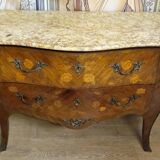 Curved Louis XV style commode with floral marquetry and marble top.