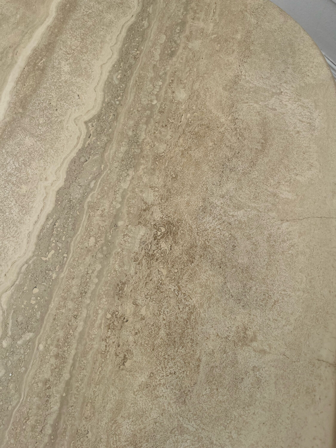 Travertine coffee table in eye shape.