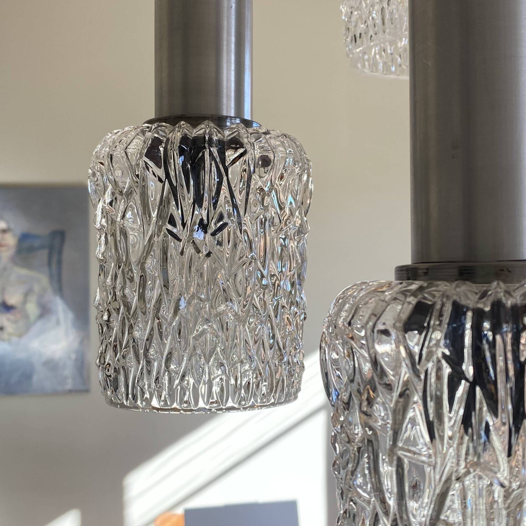 Large cascading chandelier with 5 glass lampshades and aluminium tube.