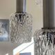 Large cascading chandelier with 5 glass lampshades and aluminium tube.