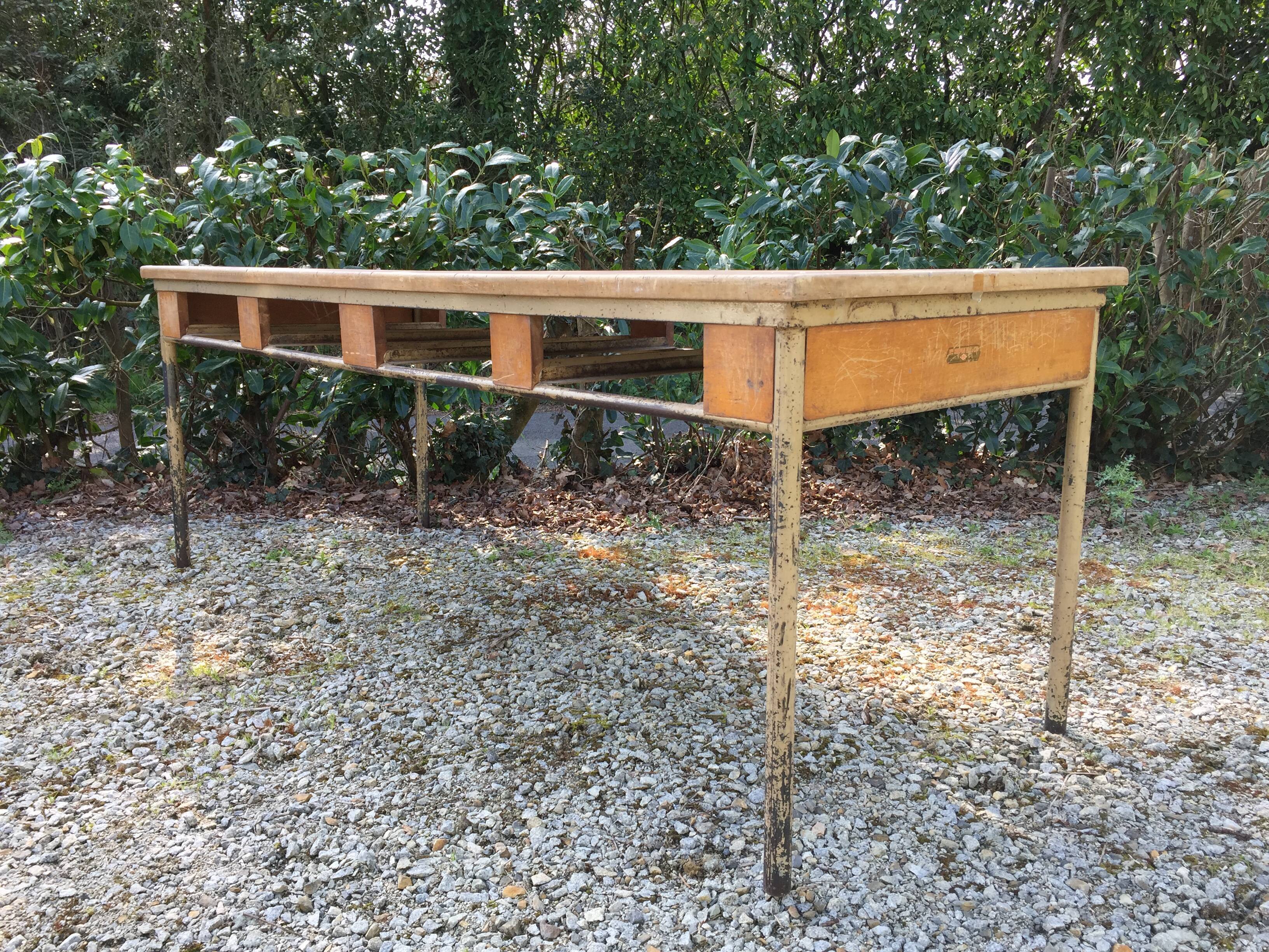 Vintage modernist table with metal tubular base and top covered with oilcloth.