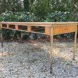 Vintage modernist table with metal tubular base and top covered with oilcloth.