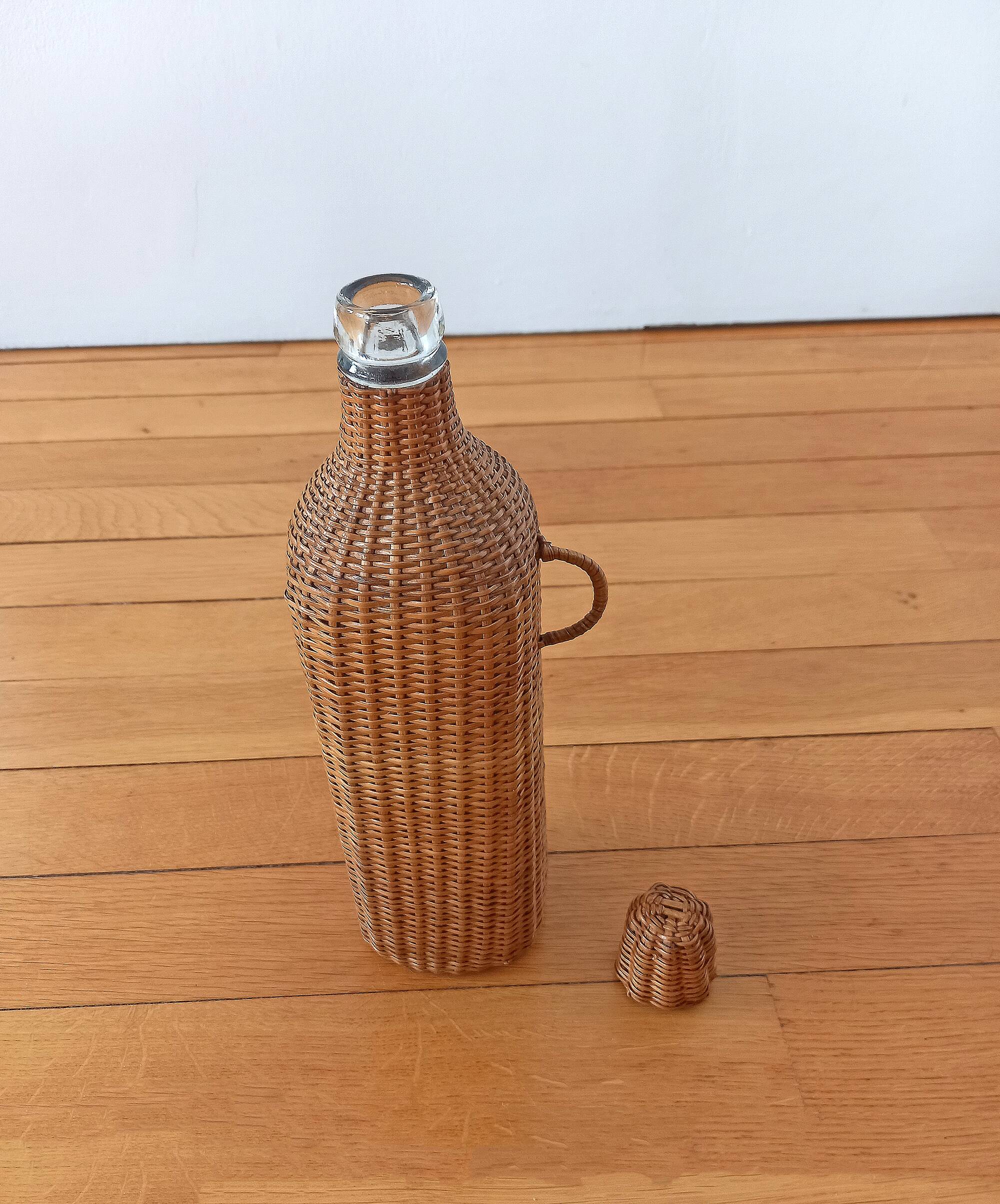 Bottle, old carafe in glass and wicker, 1950s