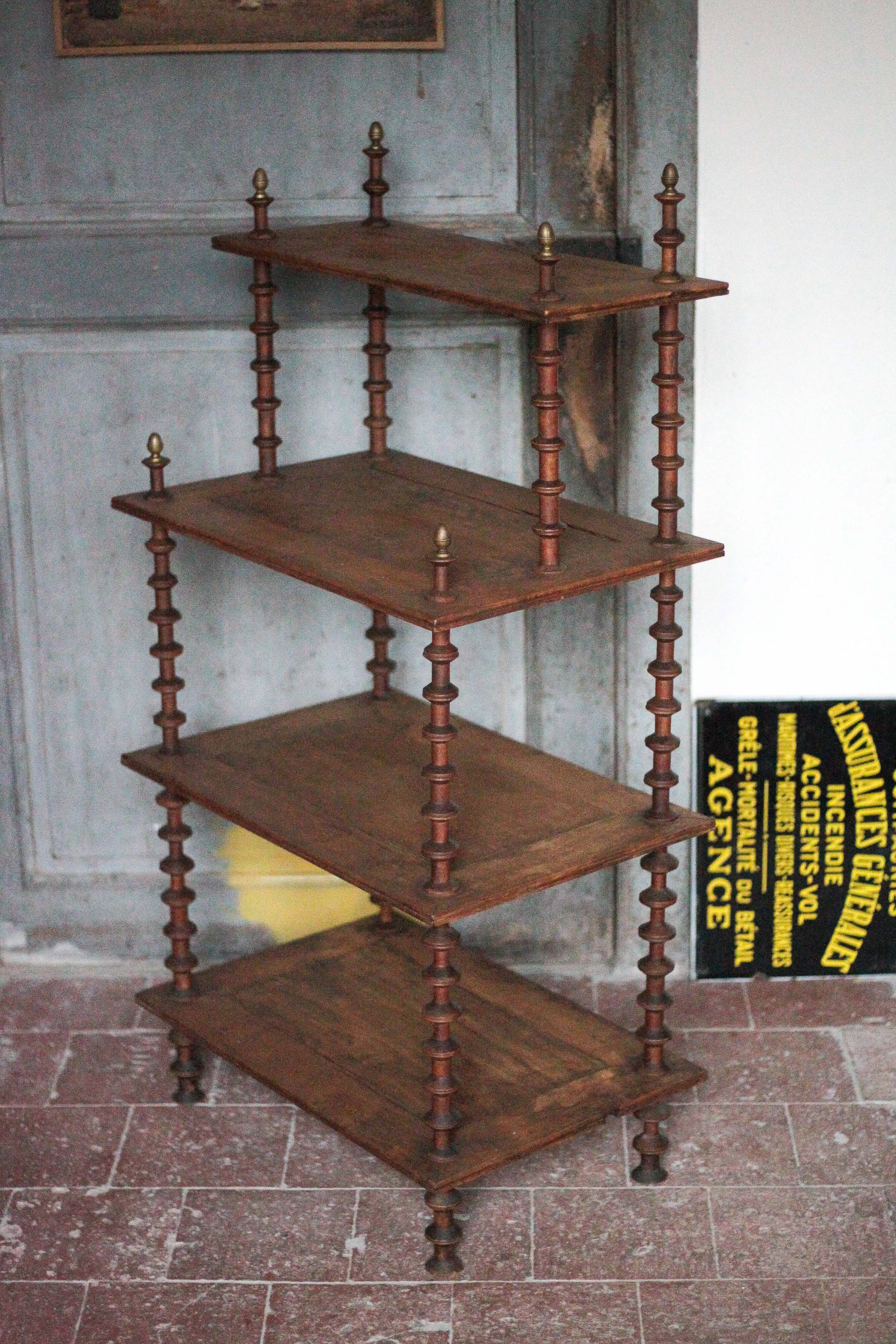 Napoleon III spool shelf, floor-standing shelf with brass tips.