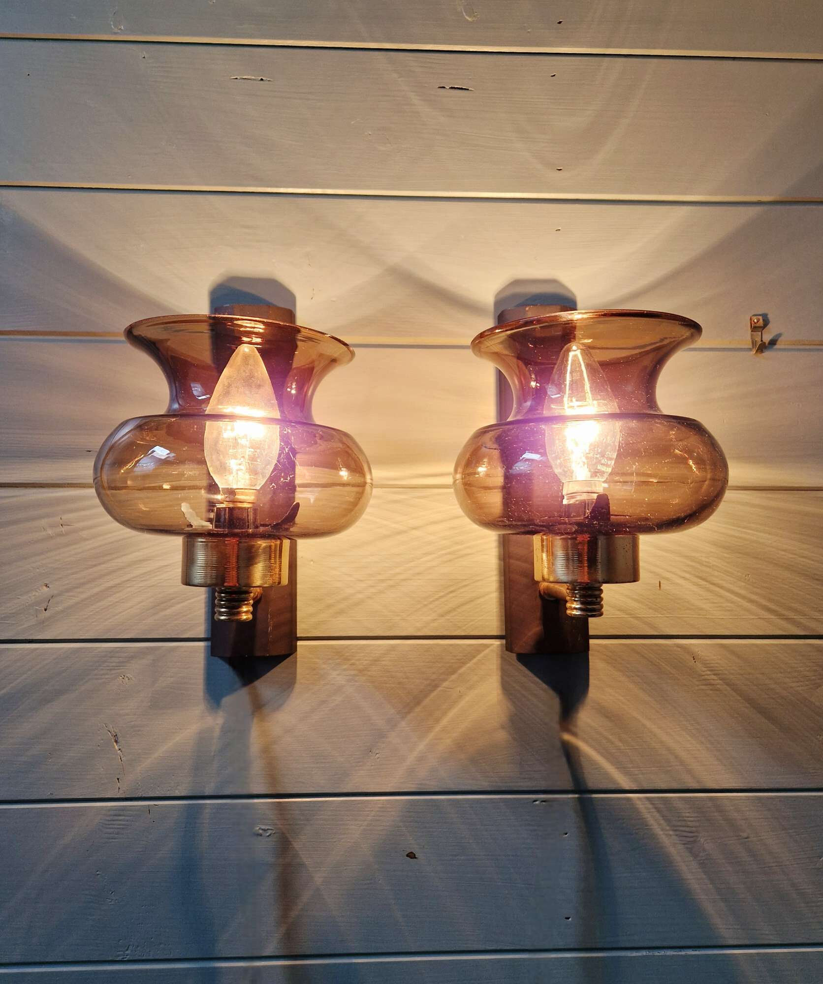 Pair of wall sconces in brass and smoked glass, 1960s.