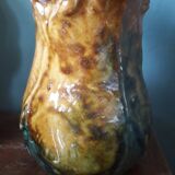 Vintage barbotine pitcher with floral decoration