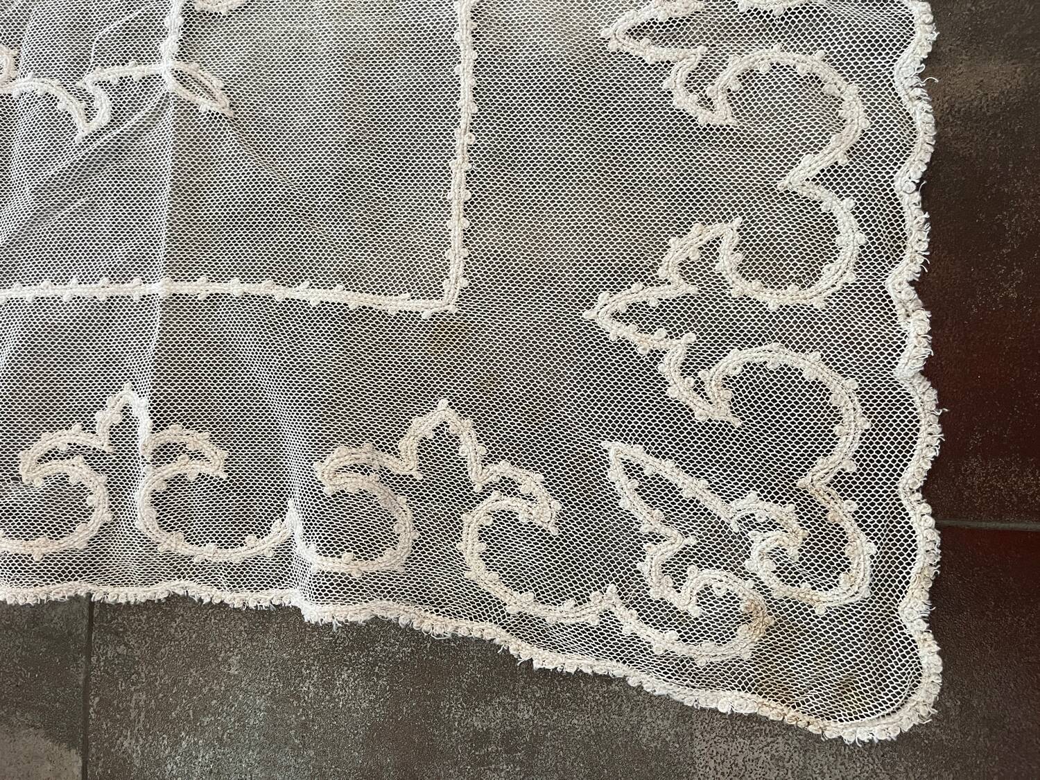 Old tablecloth embroidered with openwork embroidery.