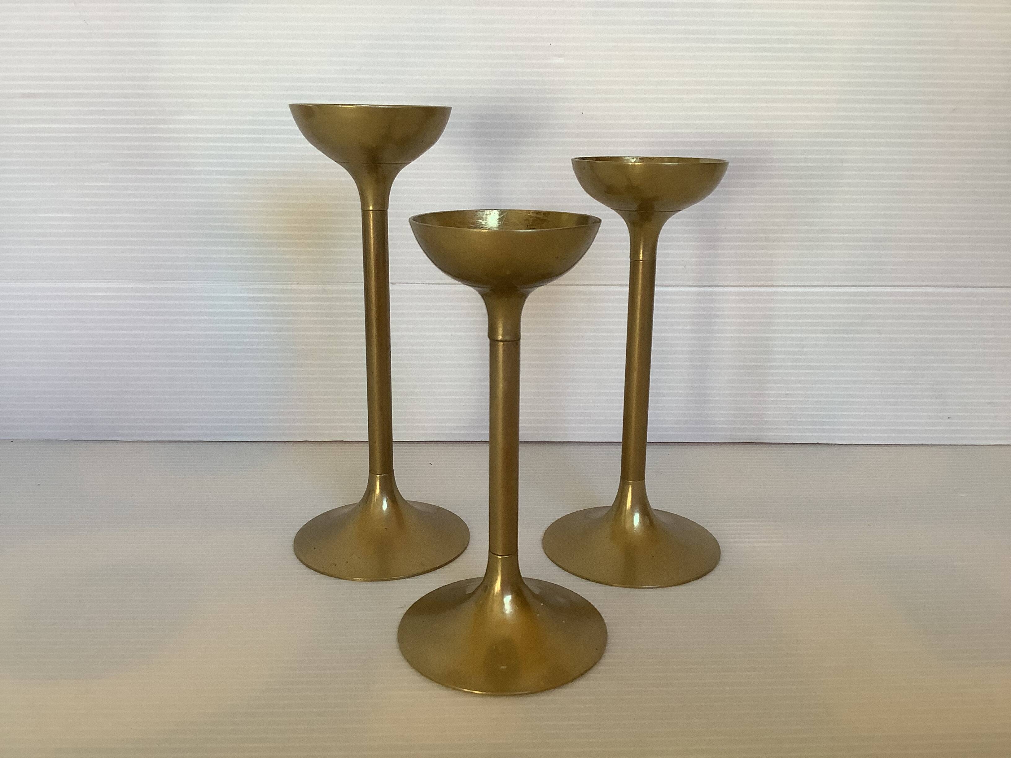Trio of brass tulip foot candle holders
