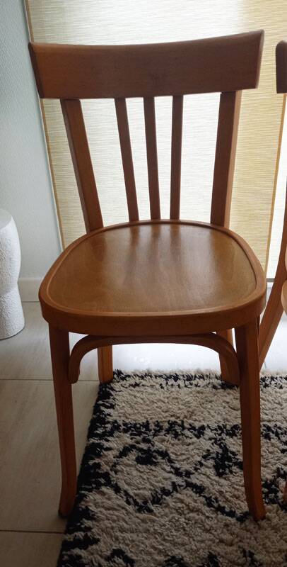 Set of 4 light wood bistro chairs stamped Baumann and Thonet.
