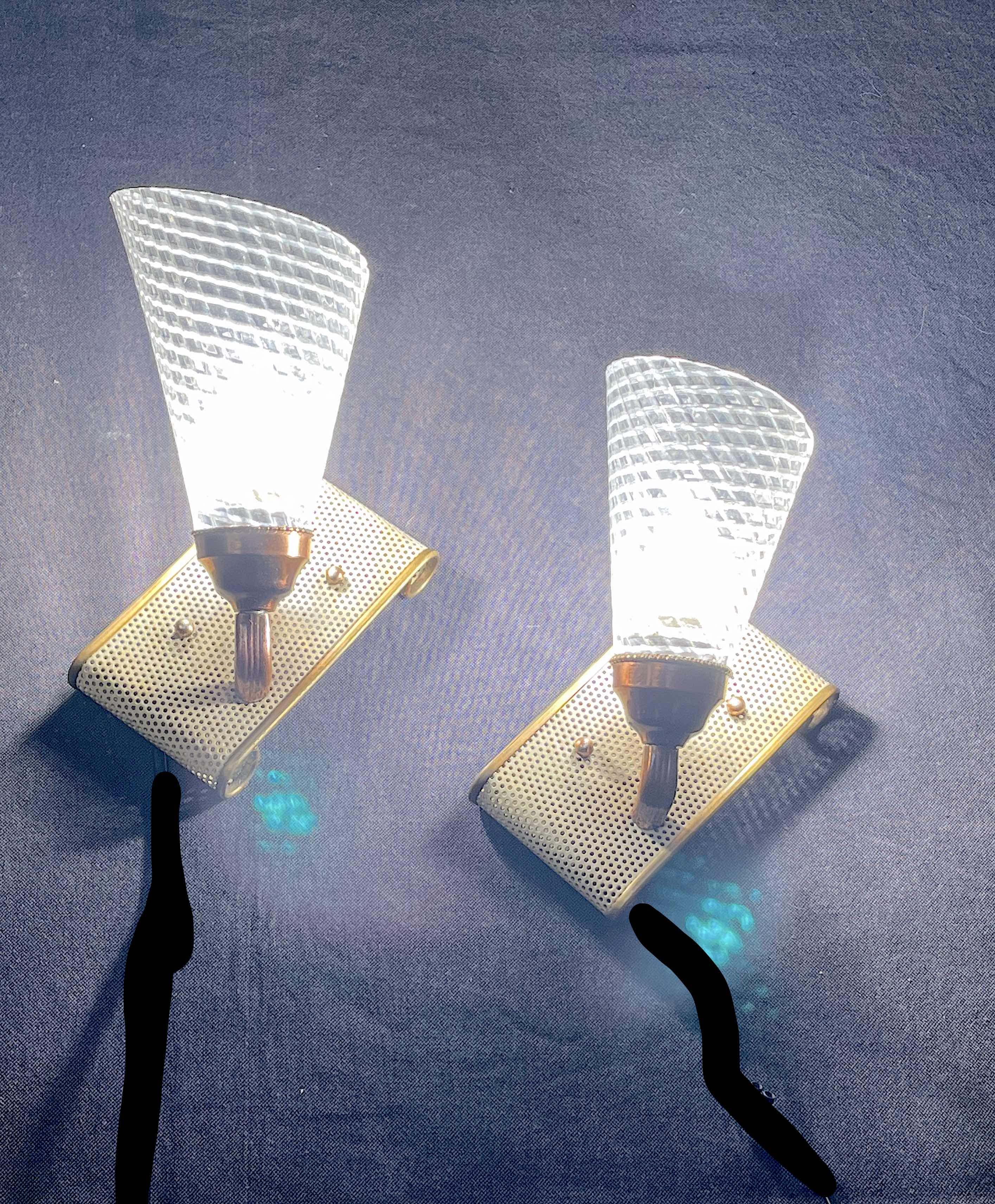 Pair of brass sconces, perforated metal and perhapx conical lampshade, France 50's